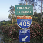 A freeway entrance sign with the interstate 4 0 5 and south signs on it.
